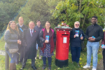 Jack with the Emersons Green Team besides a Post Box