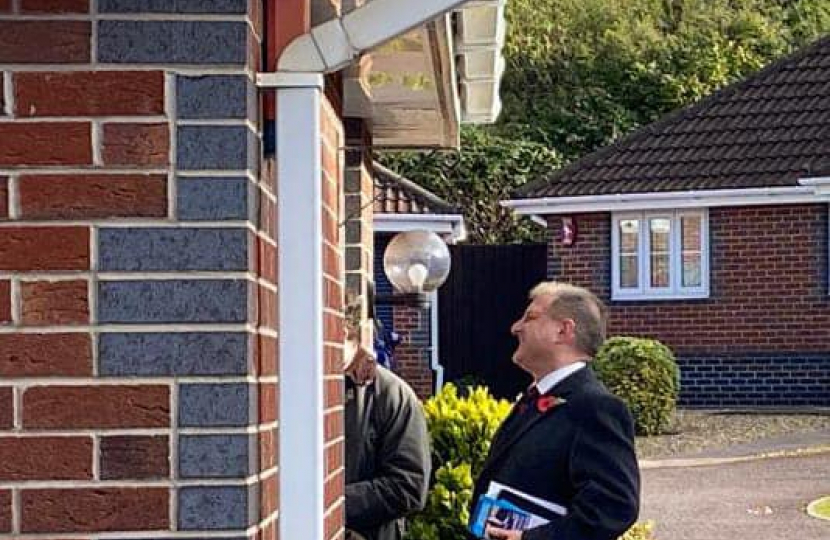 Jack speaking to a constituent at a doorstep 